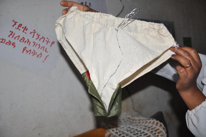 Enda Hailu, demonstrates the underwear that girls at the Maydaero school sew for their personal use, along with the sanitary pads that the school provides them.