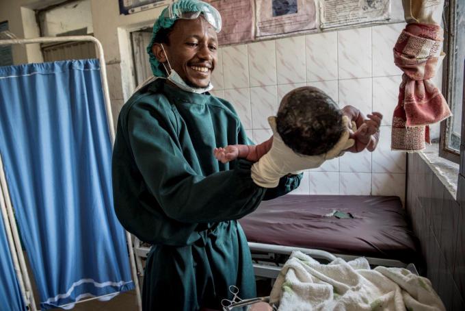 Bereket Mekonnen 28, health officer, holds newborn baby at Guba Health Center in Halaba Woreda of SNNP region.  The Guba Health Center serves 41,000 people, and on average, 68 mothers give birth there per week. It serves 11 kebeles with 11 satellite health posts.  To increase provision of high-impact, quality newborn care services in the community, health works in health centers were trained by the program. Bereket was one of the trainees in Guba Health Center.  