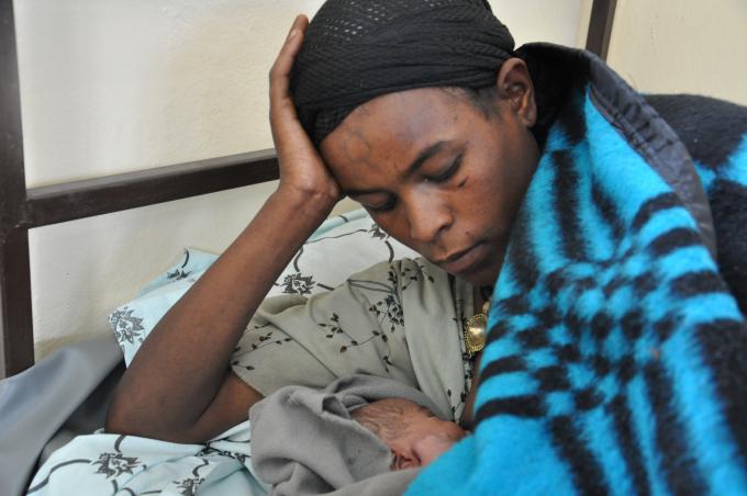 Birtukan feeding her newborn @ a maternity room constructed by Save the Children  