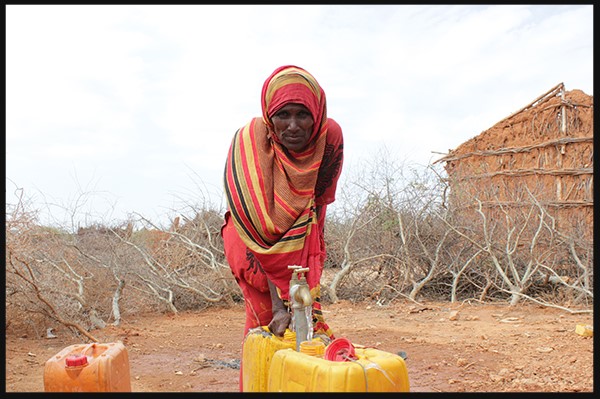 Momina fetching water from the water point 