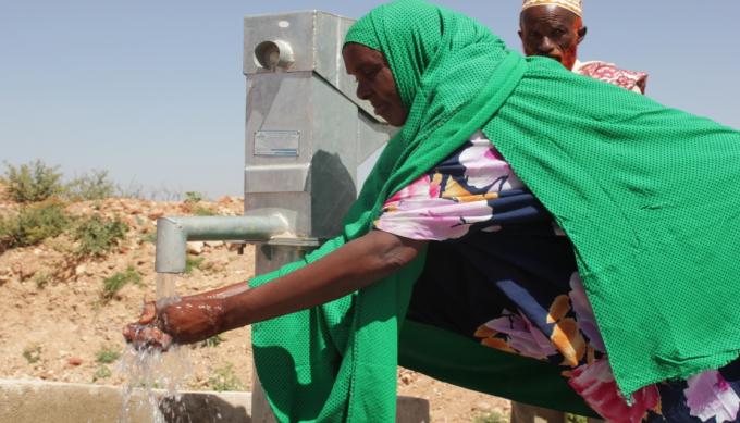 Malyun Qaman, 43, is a WASH committee. She washes her hands at the newly constructed hand pump installed on the Birkhad at Anawayalan village, in Kebribeyah district of Somali region. Save the Children through its EU WASH project, has constructed and renovated water and sanitation facilities at the community and in the schools in many parts of Somali region of Ethiopia. 
