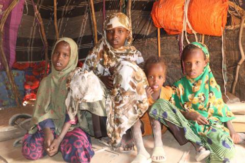 Kaltun’s four of her nine children inside their temporary shelter waiting for the food that their mother is preparing for lunch.